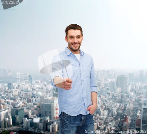 Image of smiling man pointing finger at you