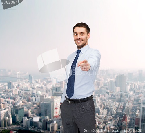 Image of handsome businessman pointing finger at you