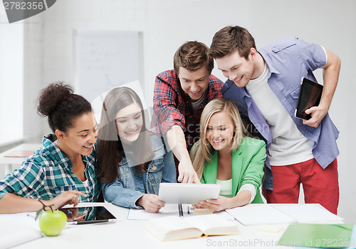 Image of students looking at tablet pc at school
