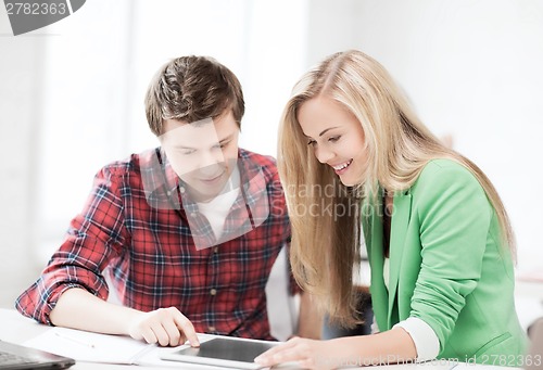 Image of students looking at tablet pc at school