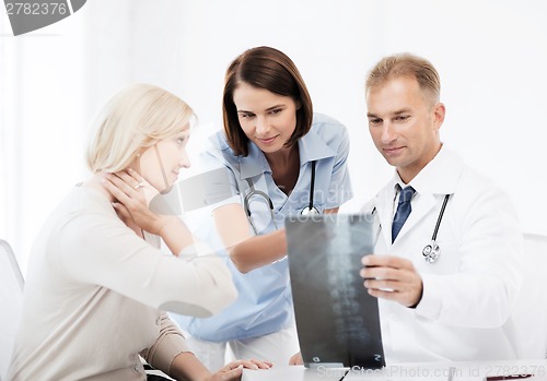 Image of doctors with patient looking at x-ray