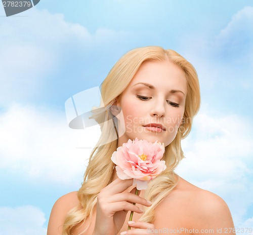 Image of lovely woman with peony flower