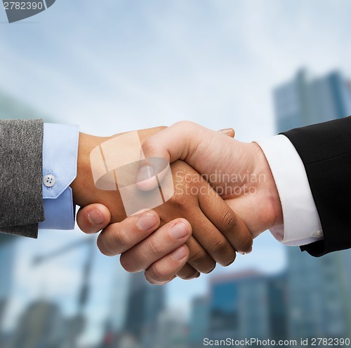 Image of businessman and businesswoman shaking hands