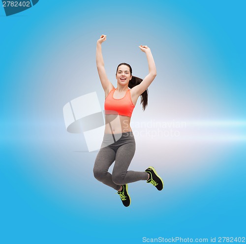 Image of sporty teenage girl jumping in sportswear
