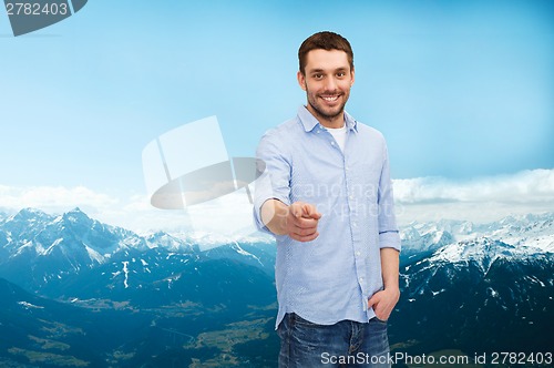 Image of smiling man pointing finger at you