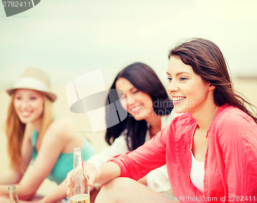 Image of girls with drinks on the beach