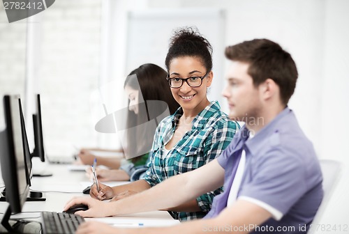 Image of african student with computer studying at school