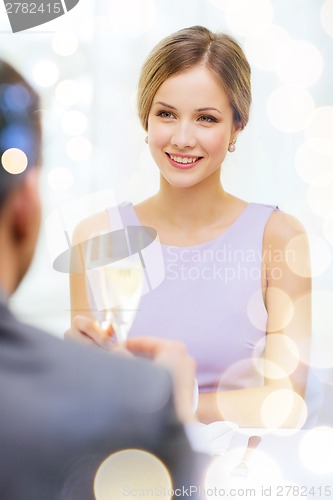 Image of couple with glasses of champagne at restaurant