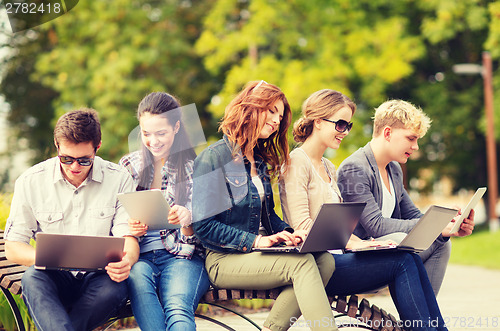 Image of students or teenagers with laptop computers