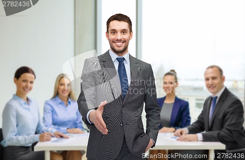 Image of businessman with open hand ready for handshake