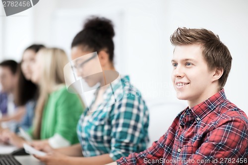 Image of student with computer studying at school