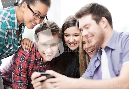 Image of students looking at smartphone