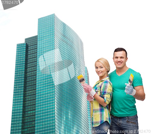 Image of smiling couple with paintbrush