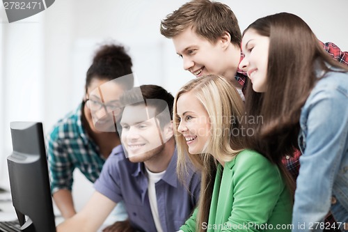 Image of students looking at computer monitor at school
