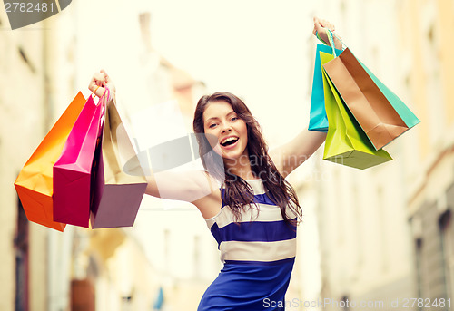 Image of beautiful woman with shopping bags in the ctiy