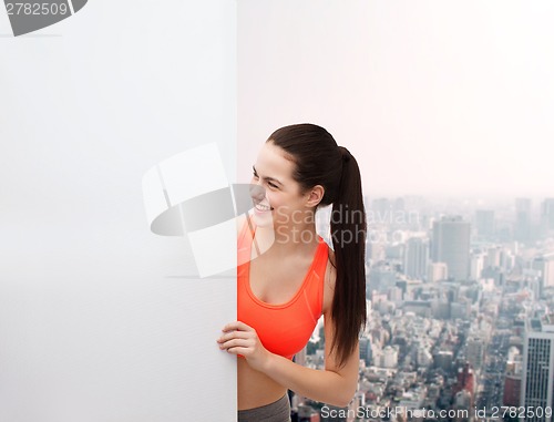 Image of teenage girl in sportswear with white board