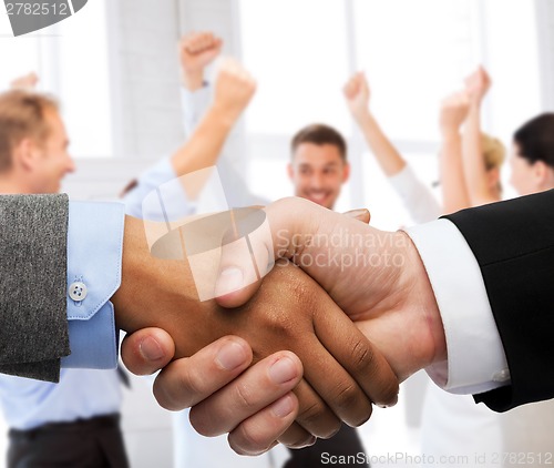 Image of businessman and businesswoman shaking hands