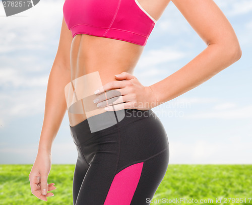 Image of close up of female abs in sportswear