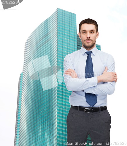 Image of handsome businessman with crossed arms