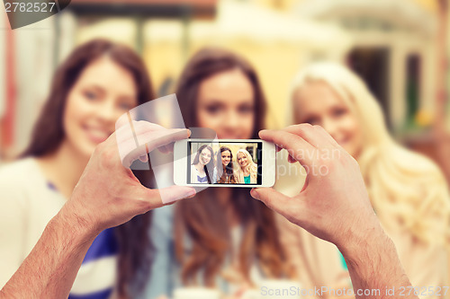 Image of close up of hands taking picture with smartphone