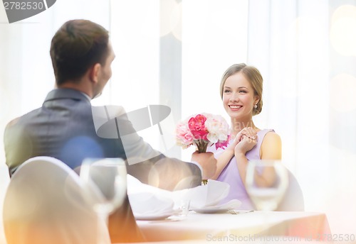 Image of smiling woman recieving bouquet of flowers