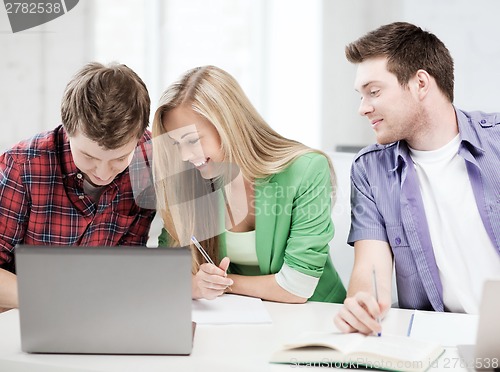 Image of students writing something at school