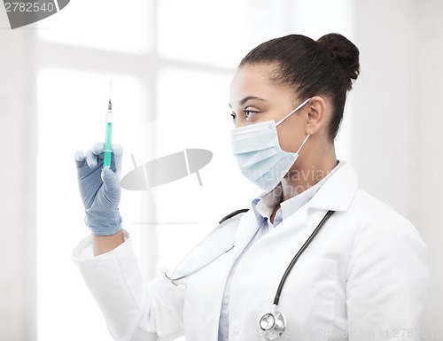 Image of african doctor holding syringe with injection