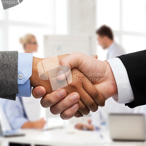 Image of businessman and businesswoman shaking hands