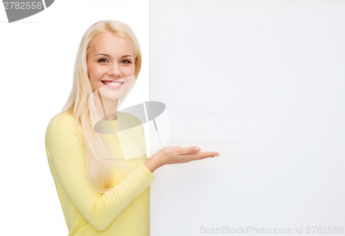 Image of smiling woman in sweater with blank white board