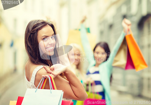 Image of beautiful woman with shopping bags in the ctiy