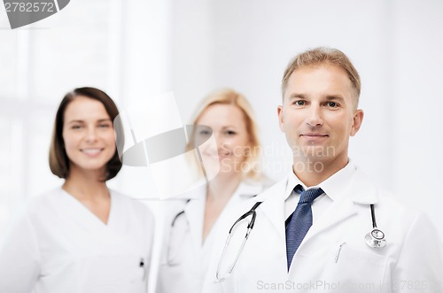 Image of doctor with stethoscope and colleagues