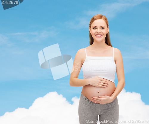 Image of happy future mother touching her belly