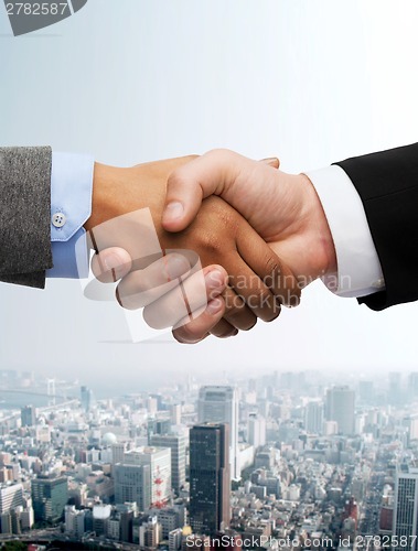 Image of businessman and businesswoman shaking hands