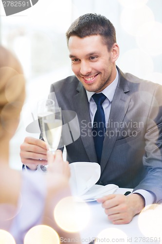 Image of couple with glasses of champagne at restaurant