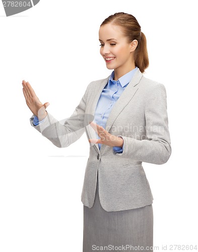 Image of smiling businesswoman pointing to something