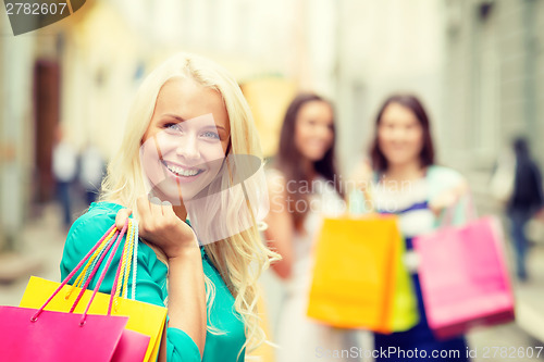 Image of beautiful woman with shopping bags in the ctiy