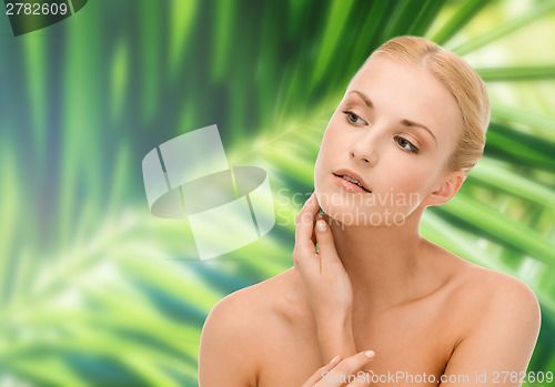 Image of beautiful woman touching her face skin