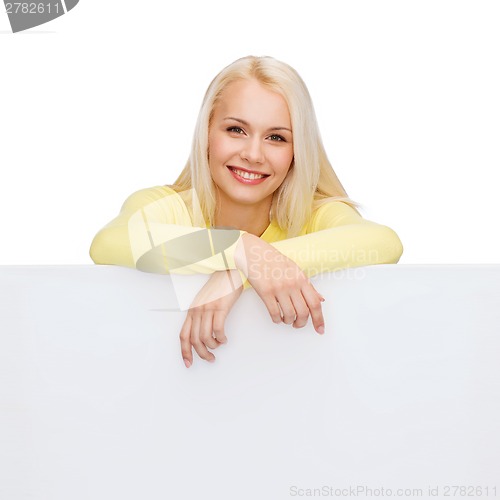 Image of smiling woman in sweater with blank white board