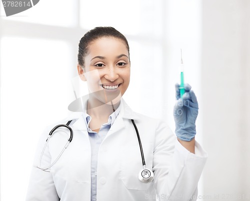 Image of african doctor holding syringe with injection