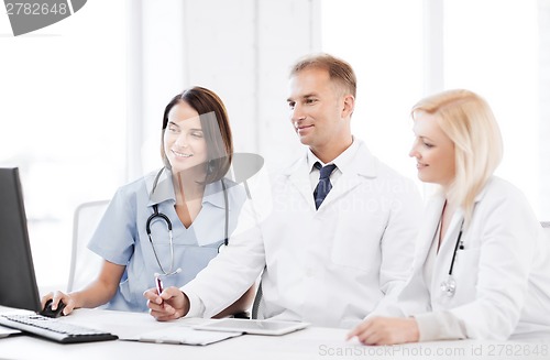 Image of doctors looking at computer on meeting