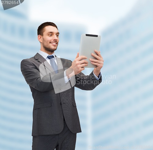 Image of smiling buisnessman with tablet pc computer