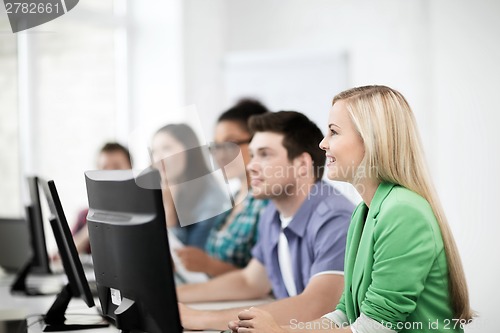 Image of students with computers studying at school