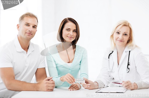 Image of doctor giving pills to patients