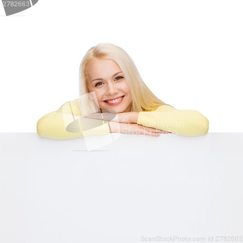 Image of smiling woman in sweater with blank white board