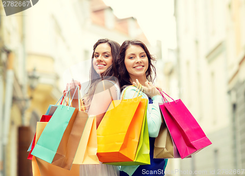 Image of beautiful women with shopping bags in the ctiy