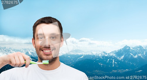 Image of smiling young man with toothbrush