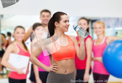 Image of sporty woman with water bottle