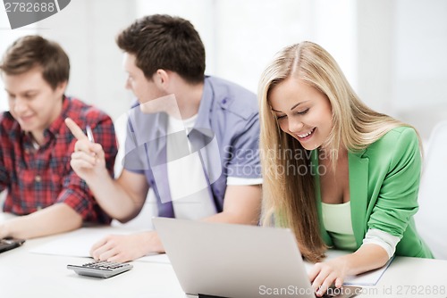 Image of students writing test or exam in lecture at school