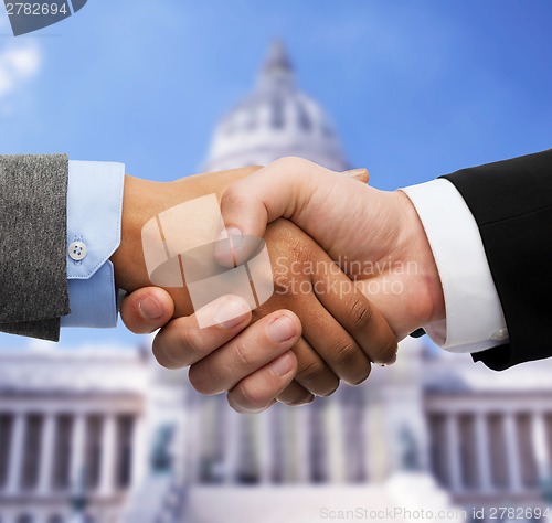 Image of businessman and businesswoman shaking hands