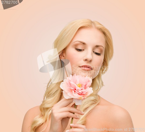 Image of lovely woman with peony flower